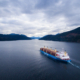 A ship loaded with raw logs leaves the Alberni Inlet on Vancouver Island.