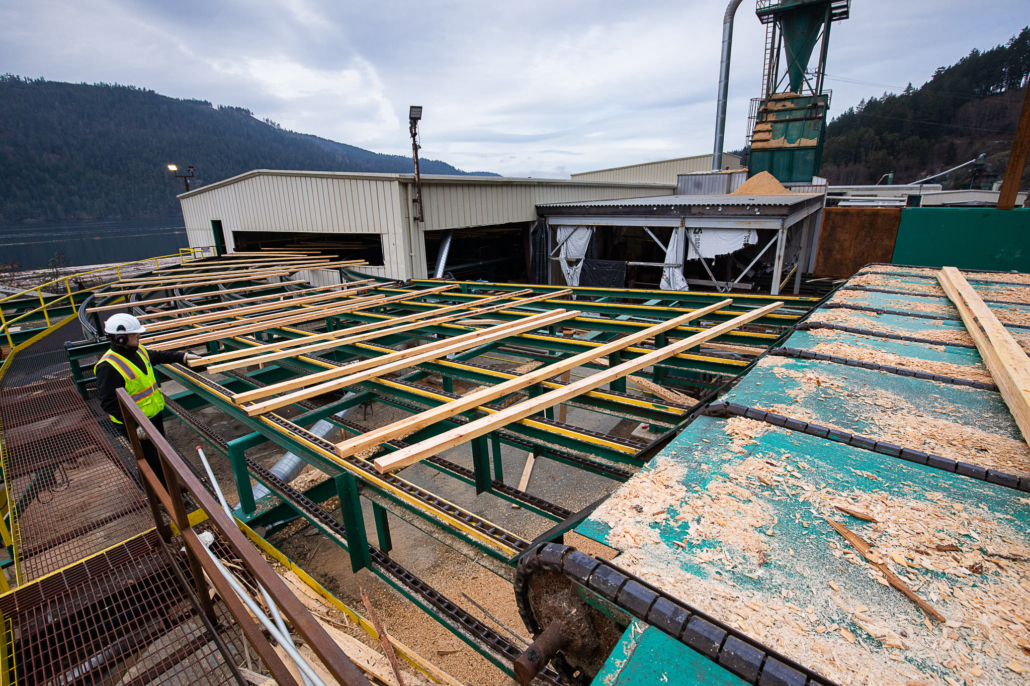 Lumber made from second-growth wood rolls through the former San Group Mill in Port Alberni. Facilities processing smaller diameter logs would have benefited from a fund with the stipulations that we are proposing.