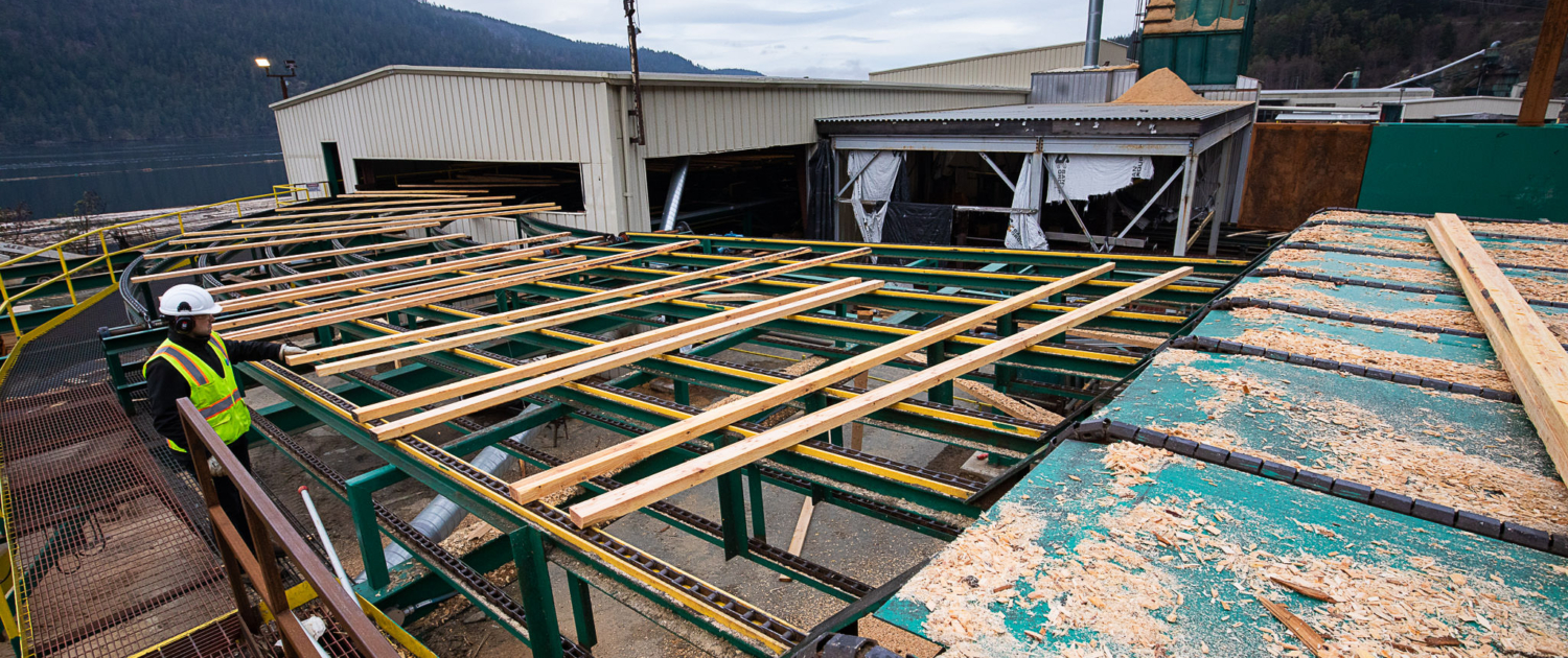 Lumber made from second-growth wood rolls through the former San Group Mill in Port Alberni. Facilities processing smaller diameter logs would have benefited from a fund with the stipulations that we are proposing.